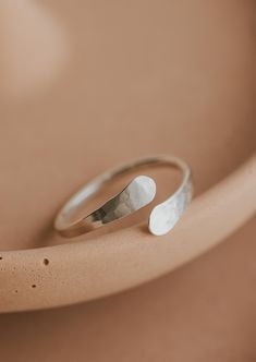 An updated version of our cuff ring. This time we made the ends pass by one another. Inspired by the definition of sonder: the realization that each random passerby is living a life as vivid and complex as your own. 14g wire is hand-shaped and hammered for texture. Available in 14kt Gold Fill + Sterling Silver. Shown with our Confetti Rings and Raye Ring. Handmade in Eau Claire, WI All of our jewelry is handmade to order so each piece will be unique and may vary slightly from what is pictured. Confetti Rings, Poppy Ring, Everyday Wear Jewelry, Cuff Ring, Cuff Rings, Circle Studs, Rings Cool, Small Rings, Beaded Rings