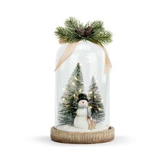 a snowman under a glass clochet with pine trees in the bottom and lights on top