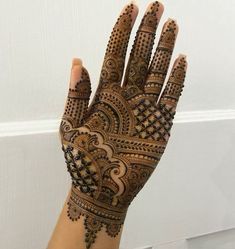 a woman's hand with henna on it