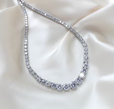 Beautiful rose gold cubic zirconia bridal tennis necklace created with Round cubic zirconia in a graduated style. This is classic style that will match any wedding gown or special occasion dress - PLEASE ALLOW APPROX 3-5 BUSINESS DAYS FOR COMPLETION BEFORE SHIPPING.- Handcrafted with Premium cubic zirconia stones - All clear stones- Rhodium, yellow gold or rose gold finish- Necklace measures 16.5 inches and extends to 18.5 inches- Nickel free and hypoallergenic This is an original design by © Treasures by Agnes FOR MATCHING PIECES SIMPLY TYPE "SOPHIE" IN THE SEARCH BAR Special Occasion Dress, Search Bar, Tennis Necklace, Clear Stone, Beautiful Rose, The Search, Beautiful Roses, Wedding Gown, Special Occasion Dresses