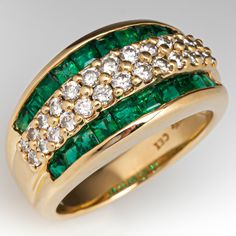 This pretty ring is centered with two-rows of thirteen (13), shared prong set, round brilliant cut diamonds. The diamonds are bordered to each side by a row of ten (10), channel set, square step cut natural emeralds. The ring measures 10.9mm at the top, rises 5.8mm above the finger, tapering to 3.8mm wide and 1.1mm thick at the base of the shank. It is currently a size 6.75. Luxury Formal Emerald Ring With Channel Set, Luxury Channel Set Emerald Ring For Formal Occasions, Formal Emerald Ring With Channel Set Round Cut, Luxury Channel Set Emerald Ring For Anniversary, Formal Channel Set Round Cut Emerald Ring, Luxury Emerald Ring With Diamond Channel Set, Luxury Emerald Diamond Ring With Channel Set, Formal Fine Jewelry Emerald Ring Channel Set, Formal Yellow Gold Emerald Ring Channel Set