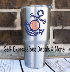 a stainless steel tumbler with an anchor and the words self expressions details & more on it