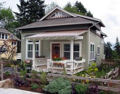 a small house with flowers in the front yard