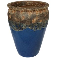 a blue and brown vase sitting on top of a table