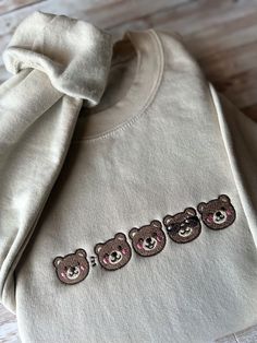 Snuggle up in our Adorable Teddy Bear Embroidered Sweatshirt - a must-have for cozy winter fashion! This cute bear design adds a touch of warmth and style to your wardrobe. Soft, versatile, and unisex, it's the perfect casual comfort for all ages. Embrace the trend with this lovable teddy bear-themed apparel. Whether you're looking for a unique gift idea or trendy winter wear, our soft and warm sweatshirt with intricate embroidery is the ideal choice. Stay fashionable and comfortable in this bear-hug of a garment! 🐻 A sturdy and warm sweatshirt bound to keep you warm in the colder months. A pre-shrunk, classic fit sweater that's made with air-jet spun yarn for a soft feel and reduced pilling. * 50% cotton, 50% polyester * Pre-shrunk * Classic fit * 1x1 athletic rib knit collar with spande Casual Long Sleeve Sweater With Bear Print, Fall Bear Print Crew Neck Top, Bear Print Crew Neck Top For Fall, Casual Bear Design Crew Neck Top, Cozy Long Sleeve Tops With Letter Embroidery, Casual Bear Print Tops For Fall, Cute Cotton Crew Sweatshirt, Cute Cotton Crew Neck Sweatshirt, Cute Custom Embroidered Tops For Fall