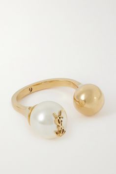 SAINT LAURENT's ring has an open, cuff-style shape. Molded from gold-tone metal with an aged finish, it has a small ball and a creamy faux pearl topped with the brand's signature 'YSL' lettering. Gold Pearl Ring, Rings Jewelry Fashion, Gold Cream, Brass Gold, Dries Van Noten, Aged Brass, Charlotte Tilbury, Pearl Ring, Manolo Blahnik