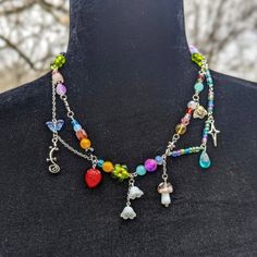 This Is A Handmade, Niche, One Of A Kind, Unique Glass And Metal, Cluttercore Necklace. This Necklace Closes With A Small Lobster Clasp Closure And A Star Accent. This Necklace Has So Many Unique And Colorful Glass Beads, Like Flowers, Mushroom, Strawberry, Lizard And More. This Measures To About 10½ Inches Long Clasped. I'm Open To Offers And Bundles Are Welcome! If You Have Any Questions Please Feel Free To Message Me Or Comment! Great For, Cluttercore, Weird Core, Cottagecore, Whimsigoth, Fai Silver Bohemian Necklace For Spring, Handmade Multicolor Fairycore Jewelry, Casual Handmade Metal Necklace, Cottagecore Whimsigoth, Weird Core, Whimsigoth Fairy, Weird Jewelry, Homemade Stuff, Glass Beads Jewelry