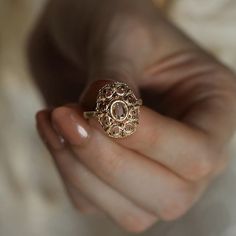 a close up of a person holding a ring