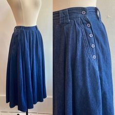 "This is a great full skirt with some nice style details. It's hard not to notice the side buttons which are functionally but also really cute. Has deep pockets and belt loops which really add to the styling options. Just enough fabric volume to swish around in and a side vent for ease of walking.  Fabric is denim-like and not heavy. More like a dark chambray.  Label is R (Roper). Definitely a Western wear piece. Condition is Great. Original size is 5/6. Please see measurements (all flat) 12.5 waist / free hip / 25\" length I'm always happy to provide more information - just send a message! ~~Condition Guide ~~ Mint: Perfect. Possibly never worn. Great: Little visible wear, lightly worn. Very Good: normal wear for the age.  Good: A few visible flaws but construction is sound and item is we Vintage Full Skirt Bottoms With Buttons, Vintage Cotton Bottoms With Buttons, Vintage Blue Bottoms With Button Closure, Vintage Full Skirt With Pockets, Vintage Full Skirt With Buttons, Retro Denim Blue Bottoms With Buttons, Vintage Spring Bottoms With Buttons, Vintage Cotton Skirt In Dark Wash, Vintage Denim Skirt With Pockets For Summer