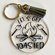 a glass keychain that says, let's get toasted on it