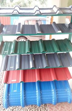 several stacks of different colored metal roofing sheets