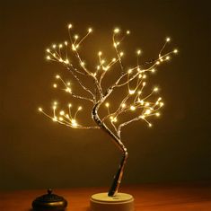 a lighted tree is sitting on a table