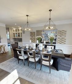 a dining room table and chairs with chandelier