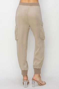 Discover the ultimate blend of style and comfort with our Taupe High Rise Haven Joggers. Designed to elevate your everyday look, these joggers are perfect for those who seek both fashion and functionality in their wardrobe. Key Features: High Rise Fit: Flattering and comfortable, these joggers sit perfectly at the waist, providing a sleek silhouette. Versatile Taupe Color: The neutral taupe shade makes these joggers easy to pair with any top, ensuring they become a staple in your closet. Premium Tercel Fabric: Crafted from high-quality tercel, these joggers offer a luxurious feel with exceptional durability. Cargo Pockets: Functional and stylish, the cargo pockets add a trendy touch while providing ample storage for your essentials. Elastic Waistband and Cuffs: The elastic waistband ensure Utility Style Sweatpants For Loungewear, Khaki Sweatpants With Pockets For Loungewear, Elevated Casual Stretch Sweatpants With Pockets, Stylish Stretch Sweatpants With Pockets, Stretch Sweatpants With Pockets For Elevated Casual, Parachute Pants With Cargo Pockets For Loungewear, Spring Loungewear Sweatpants With Cargo Pockets, Utility Relaxed Fit Joggers For Loungewear, Relaxed Fit Utility Joggers For Loungewear