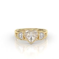 a heart shaped diamond ring with three stones on the band and two diamonds in the middle