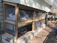 an outside view of a house with some animals in it