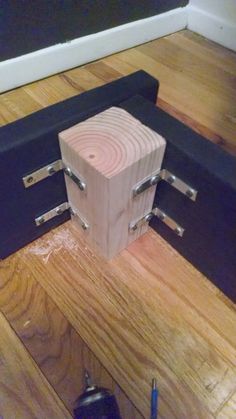 a wooden block sitting on top of a hard wood floor