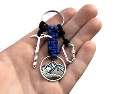 a hand holding a keychain that has some items on it