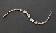 A simplistic pearl bracelet covered in stunning round cubic zirconia that create a lovely leaf shape. It is 7 inches long, .5 inches wide rhodium, gold or rose gold plated, Grade AAA CZ, lead free. Wedding Bracelet, Leaf Shapes, Pearl Bracelet, Rose Gold Plates, Design Crafts, Or Rose, Fresh Water, Freshwater Pearls, Pearl Necklace