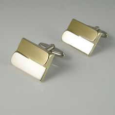 A unique pair of mid century fine sterling silver gold plated accent one of a kind cufflinks circa 1950.These classic 1950s cufflinks have gold plated accents and a unique design which catches the light from every angle.The front of the cufflinks is plated in gold and the backs and cuff link fittings are silver.The design is quite timeless.Together they weigh 14.33 grams.They are each clearly marked on the cuff link fittings 835 for fine European silver.Each of the classic design cufflink faces Modern Polished Cufflinks For Wedding, Modern White Gold Cufflinks For Wedding, Elegant Cufflinks With Gift Box, Modern Jewelry With Gift Box, Modernist Rectangular Jewelry For Formal Occasions, Elegant Rectangular Cufflinks With Polished Finish, Luxury Rectangular Cufflinks For Wedding, Luxury Rectangular Cufflinks For Anniversary, Modern White Cufflinks For Formal Occasions