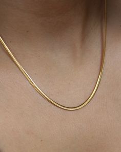 This 18K gold plated SLINKY ESSENTIAL CHAIN is the perfect addition to your everyday wardrobe. Made of high-quality stainless steel, this chain is durable and versatile, making it suitable just any occasion. It's an essential piece that will layer perfectly with any other chain or pendant necklace . Classic Gold Herringbone Necklace With Snake Chain, Elegant Gold-tone Snake Chain Necklace As Gift, Classic Yellow Gold Snake Chain Necklace, Everyday Gold-plated Snake Chain Necklace, Classic Gold Snake Chain Necklace With Delicate Chain, Everyday Yellow Gold Adjustable Snake Chain Necklace, Elegant Gold-tone Snake Chain Necklace With Adjustable Chain, Classic Gold Snake Chain Necklace, Classic Gold Delicate Snake Chain Necklace