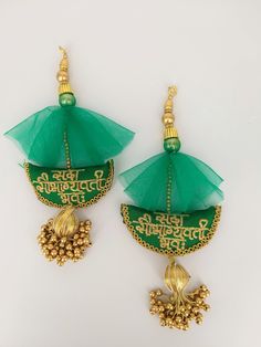 This listing is for Beautiful and one of a kind Green Art Silk Fabric Tassel With Antique Gold Embroidery, Wedding Lehenga, Dress Blouses, Indian Embellishment.  This embellishment is ideal for an Indian wedding. It has the sanskrit blessing 'Sada Saubhagyavati Bhava' embroidered on it. This is a sanskrit blessing only given to a woman getting married or is married. 'Sada' means 'always', 'Saubhagyavati' means 'a woman lucky in marraige' and bhava mean 'May you be'.  It is a beautiful embellishment that would make any bridal accessory stand out  Handmade Measurements: End to End: Approx. 19.5 cm x 7.5 cm This stunner can be used for any of the following:  *Dress Design: Wedding Dresses, Festive Wear, Ethnic wear *Saree Embellishments, Blouse Embellishments, Salwar Kameez Embellishments *To Bohemian Handwork Traditional Wear For Wedding, Bohemian Traditional Wear With Handwork For Wedding, Green Embroidered Fabric For Wedding And Navratri, Traditional Green Lehenga With Handwork, Green Bollywood Embroidered Fabric For Wedding, Bollywood Style Green Embroidered Fabric For Wedding, Green Anarkali Embroidered Fabric For Wedding, Wedding Festival Dupatta With Handwork, Green Wedding Lehenga With Handwork