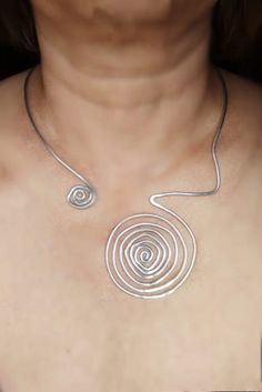 Choker necklace silver plated wire spiral jewelry Swirls necklace Asymmetric necklace Open silver necklace Collar choker Modern necklace Handmade necklace made of silver plated wire wire (2.5 mm, 10 gauge ). Silver plated wire is a metal that does not change its properties, does not tarnish ,and is not damaged over time. Nickel free and lead free. Silver plated wire is a soft metal, so the necklace is flexible and easily adjustable, but It's possible to adjust the necklace just a little bit, but not too much not to lose the form. The standard size is appropriate for my neck line so you can have the orientation according to the photo. Silver Swirl Necklace, Spiral Wire Wrapped Sterling Silver Necklace, Silver Wire Wrapped Choker Jewelry, Handmade Spiral Silver Necklace, Silver Spiral Metal Necklaces, Silver Wire-wrapped Necklace, Adjustable Spiral Silver Necklace, Silver Plated Wire Wrapped Necklaces, Silver Wire Wrapped Metal Necklace