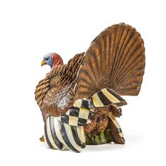 a figurine of a turkey with striped feathers on it's back legs