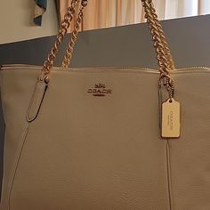 Handbag New With Tag Purchased From Coach Store In Ga. Never Used. Handbag Has Pebbled Grain Leather Gold Hardware Chain And Leather Strap Roomy Handbag A Classic Everyday Cream Bag With Chain Strap, Coach Leather Bag With Chain Detail, Coach Gold Shoulder Bag With Chain Strap, Cream Leather Bag With Chain Strap, Coach Bag With Chain Strap For Everyday Use, Chic Coach Bag With Chain Detail, Coach Bags With Chain Strap For Daily Use, Chic Coach Bag With Chain, Daily Use Coach Shoulder Bag With Chain Strap