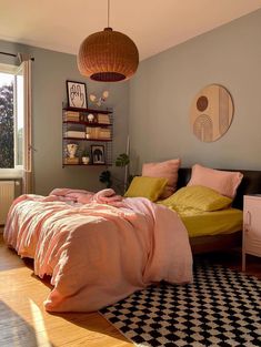 a bed room with a neatly made bed next to a window and a black and white checkered rug