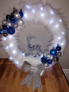 a white wreath with blue and silver ornaments