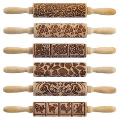 four wooden rolling pins with designs on them