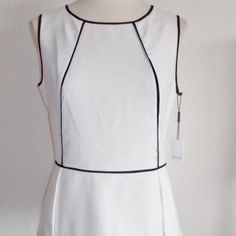 Calvin Klein Misses Size Medium Fashion Blouse / Top Off White In Color With Black Piping Sleeveless Peplum Waist Back Zipper With Hook & Eye Closure 97% Polyester 3% Spandex Chic White Peplum Top, White Sleeveless Office Top, Chic White Peplum Blouse, White Elegant Peplum Top, Elegant White Peplum Top For Summer, White Fitted Peplum Top, Elegant Sleeveless Spring Peplum Top, Elegant Sleeveless Peplum Top For Summer, Calvin Klein White Workwear Tops