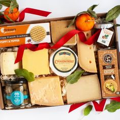 an assortment of cheeses and crackers in a box