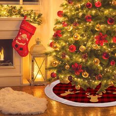 a christmas tree with stockings on it in front of a fireplace