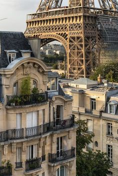 the eiffel tower towering over paris is seen in this view from an apartment building