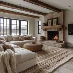 a living room with couches and a fire place in the middle of the room