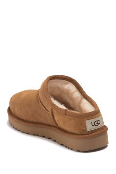 UGGplush, a moisture-wicking textile made from a wool-rich blend but crafted to feel and wear like genuine shearling, lines a timeless suede slipper designed with a rugged sole for indoor or outdoor wear. Slight dye transfer may occur with darker colors during first few wears Leather upper/UGGplush wool blend lining/synthetic sole Imported Ugg Classic Slipper, Ugg Slippers Outfit, Slipper Outfit, Cute Uggs, Slippers Outfit, Classic Slippers, Trendy Shoes Sneakers, Preppy Shoes, Suede Slippers