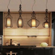 three lights hanging from the ceiling in a kitchen