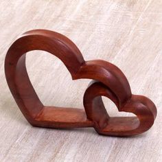 two wooden hearts shaped like an interlocking ring