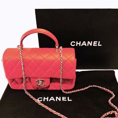 Chanel Red Lambskin Mini Rectangular Top Handle Flap This stunning Chanel mini flap top handle bag is a timeless and chic accessory that is perfect for any occasion. The bag is crafted from luxurious lambskin leather in a beautiful red color. The bag features a leather top handle, a gold chain link shoulder strap threaded with leather and a frontal flap with a gold Chanel Classic CC turn lock. This opens to a leather interior with zipper and patch pockets. Designer: Chanel Material: Lambskin leather Origin: Italy Date/ Code: Microchip Production Year: 2022 Measurements: 7.75" x 4.75" x 2.25" (wxhxd) Drop: 1.5" handle; 22" strap Closure/Opening: CC turn-lock Interior Lining: Leather; Fine textile Hardware: Light gold-tone metal Includes: Chanel box, dust bag, ribbon & Entrupy COA Overall Co Chanel Material, Chanel Box, Chanel Mini, Gold Chanel, Chic Accessories, Luxe Fashion, Exclusive Bag, Handle Bag, Leather Interior