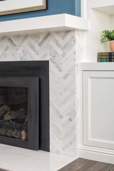 a fireplace with white and blue walls in a living room