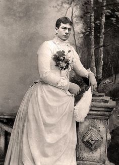 an old photo of a woman in a dress