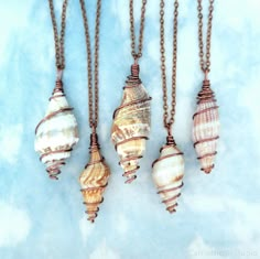 These beautiful natural sea shell necklaces are made with lovely spiral shells and antique copper jewelry wire. Each pendant is unique, with varying colors and sizes, but maintains the same swirled wire design. They hang on delicate, yet sturdy 2mm antiqued copper cable chain necklaces, which are cut and finished by hand with lobster clasp closures. The shells vary in size, measuring around 1.5 to 2.1 inches long, and they are about 0.4 to 0.7 inches wide in the middle section. These boho-styled Wire Wrapped Seashells, Sea Shell Pendant, Wire Wrapping Shells, Wire Wrapped Sea Shells, Wire Wrapped Shell Jewelry, Shell Pendant Necklace, Sea Shell Necklace Diy, Sea Shell Jewelry Diy, Things To Make With Shells