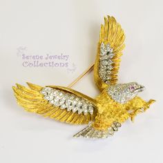 Absolutely beautiful McTiegue 18k gold Vintage Eagle Brooch designed in both platinum and 18k yellow gold! Exactly 100 white sparkly diamonds adorn the eagle's wings, tail and head, and has a ruby eye! Powerful piece! Total Weight: 26.5 grams Size: 2.3 inch x 2 inch Precious Metal: 18k yellow gold, Platinum Precious stones: -Ruby Eagle eye: 1.3mm, QTY: 1 -White Round Diamonds: QTY: 100, 2 carats Hallmark: Plat, 18k Eagles Wings, Platinum Diamond Rings, Eagle Eye, Jewelry Pins, Brooch Vintage, Antique Diamond, Platinum Ring, Precious Metal, Vintage Designer