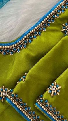 a green and blue dress with beading on it