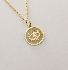 14K Real Solid Gold Evil Eye Pendant ● Material of pendant: Solid Gold 14k ( REAL GOLD ) ● Metal Stamp: 14L ( REAL GOLD ) ● The pendant is available in 6 sizes: - 14,0 mm / 0,55 inches ( Diameter ) In the photos - 15,3 mm / 0.60 inches ( Diameter ) - 16,5 mm / 0,65 inches ( Diameter ) - 19,1 mm / 0,75 inches ( Diameter ) - 21 mm / 0,82 inches ( Diameter ) - 23 mm / 0.90 inches ( Diameter ) ( In the photos the size is 14mm / 0.55 inches Diameter ) ( Jump Ring inner diameter: 4 mm ) ● Material Of Gold Round Charm Necklaces For Good Luck, Gold Engraved Charm Necklace For Good Luck, Symbolic Yellow Gold Jewelry Gift, Symbolic Gold Jewelry For Birthday, Gold Tarnish-resistant Jewelry For Birthday, Gold Symbolic Charm Necklaces For Anniversary, 14k Gold Charms Jewelry For Birthdays, 14k Gold Charms Jewelry For Birthday, Gold Medallion Jewelry For Birthday