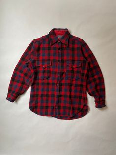 "Pendleton Plaid Wool Button Down Shirt Size: Medium Era: 1970's Material: Wool Made in USA Details: Red and Navy Plaid Wool Button Down Shirt with Two Flap Button Pockets.  Thick Wool Material.  Two Front Buttons Missing.  Good Conditions with No Holes or Stains.  Chest (Armpit-Armpit) : 22\" Sleeve (Shoulder-SleeveEnd) : 22.5\" Length (Neckline-Bottom) : 30\"" Red Crewneck, Hunting Jackets, Thick Wool, Pendleton Wool, Wool Plaid, Shoulder Sleeve, Button Downs, Down Shirt, Made In Usa