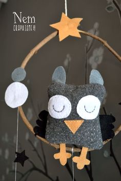 an owl is hanging from a hoop with stars