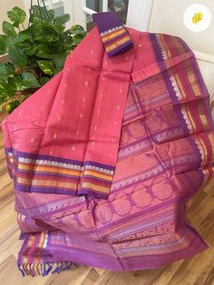 A super pretty coral pink handwoven SICO (silk by cotton) gadwal with purple contrast pallu and border. Gorgeous color. Very comfortable and elegant drape. Fall and pico done, blouse piece separated. Purple And Pink Border Sarees, Pink Cotton Handloom Saree, Pink Cotton Handloom Dupatta, Pink Cotton Silk Traditional Dupatta, Traditional Pink Cotton Silk Dupatta, Pink Cotton Silk Traditional Wear For Festivals, Pink Traditional Wear With Border For Puja, Pink Tussar Silk Traditional Wear With Border, Pink Cotton Dupatta For Puja